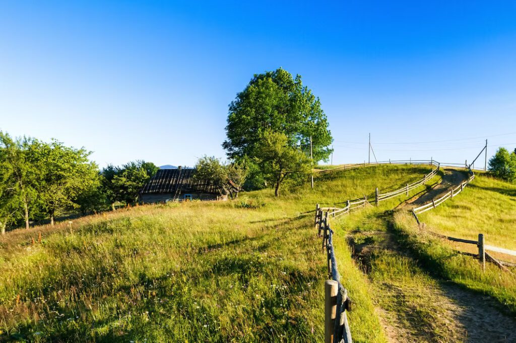 beautiful view village in ukrainian capathian mountains installing a fence