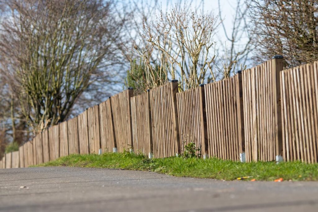 Landscape shot on brown wooden fence managing with fence cost